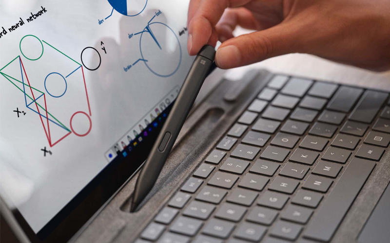 Person placing the surface pen into the surface keyboard