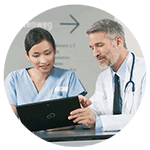 Doctor and nurse review patient data on tablet device