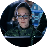 Woman military member looking at screen
