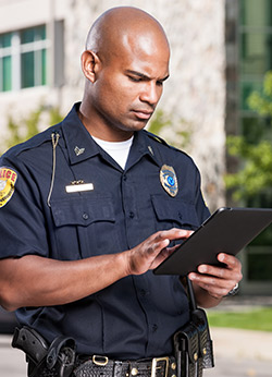 Police officer using tablet device