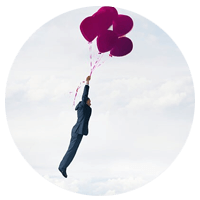 Conceptual image of businessman floating through clouds holding on to balloons. 
