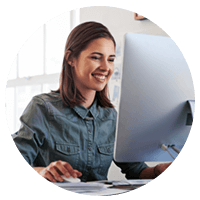Smiling business woman using EDI technology on computer