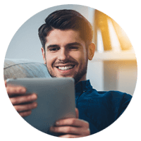 Smiling man holds tablet device in hands