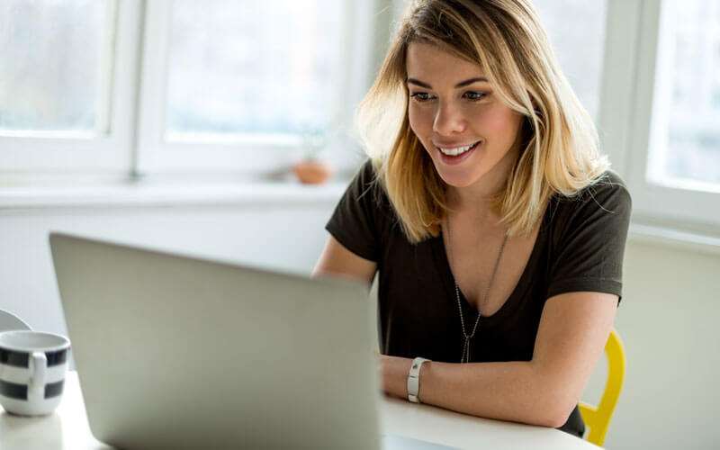 Woman smiling over laptop computer