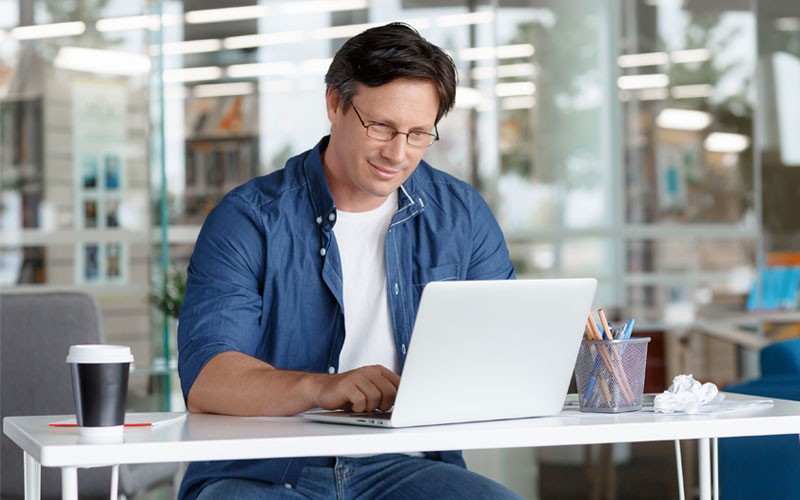 Business man using laptop at desk