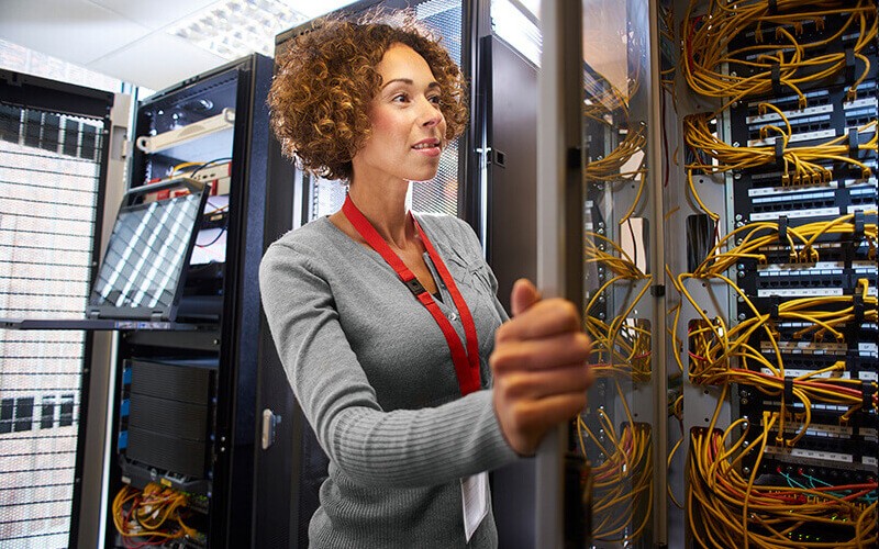 IT technician reviews server logistics in data center