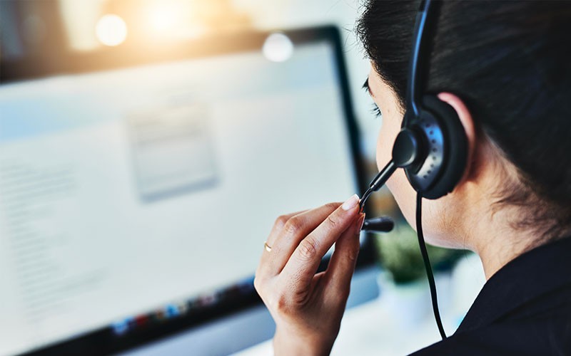 Call center representative in office with headset