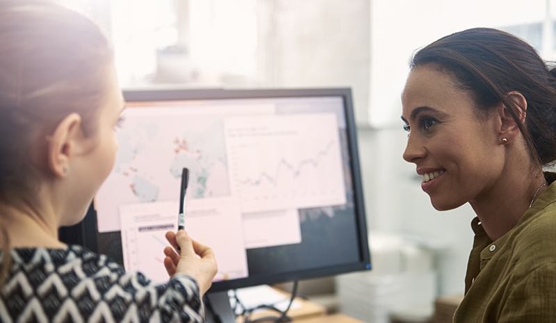 Two women looking at computer