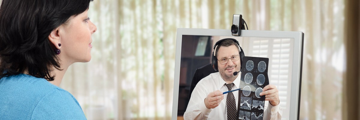 Doctor delivering telehealth services to a woman over video chat