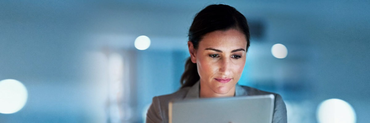 Business woman reviewing data off tablet computer