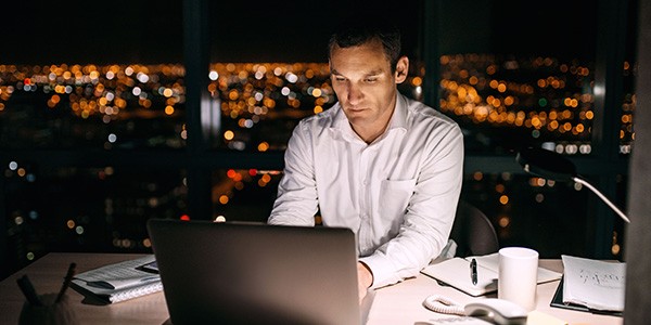 business man working on laptop at night