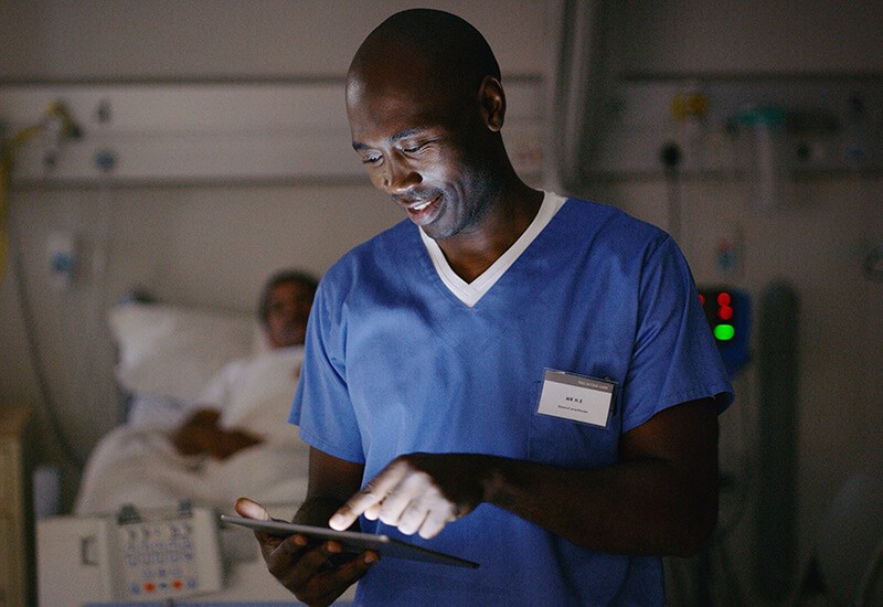 Healthcare worker in patient care using digital device