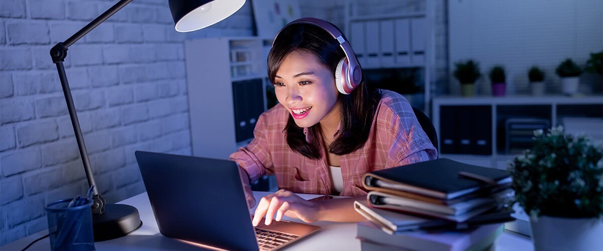 Woman with headphone using laptop