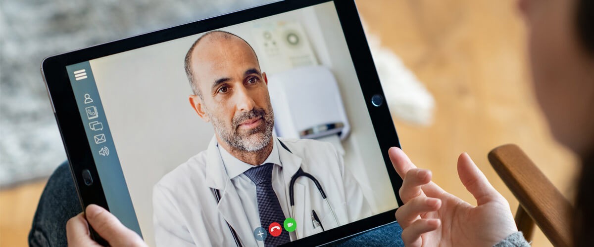 Woman speaking to a doctor through video chat on a tablet