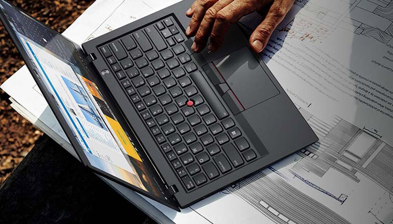 Close up of hand navigating a Lenovo ThinkPad device. Workplace transformation, Lenovo ThinkPad