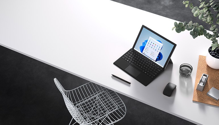 Microsoft Surface device on desk displaying Windows 11 OS