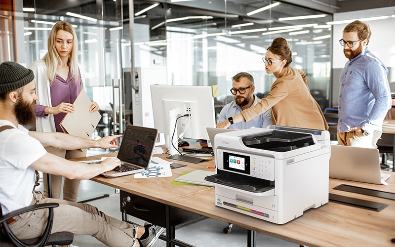 Group of creators working in office with Epson printer
