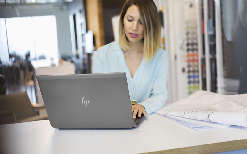 Woman working using a HP laptop
