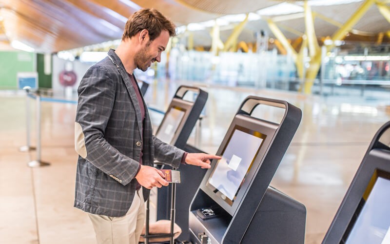 Man using kiosk while traveling
