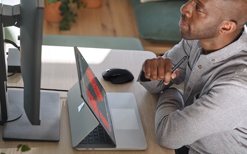 Man working on Surface Laptop Studio