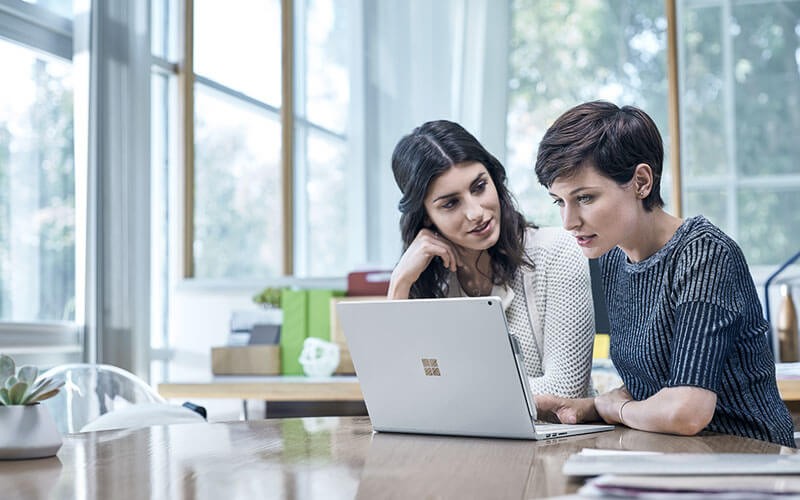Women working on Microsoft Surface device