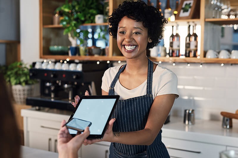 Customer buys using smart device on cafe's tablet point-of-sale (POS) device