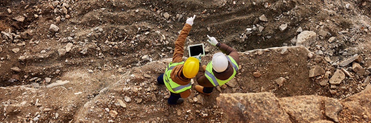 Mining men working on tablet device