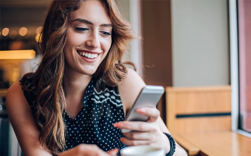 Smiling woman on mobile device